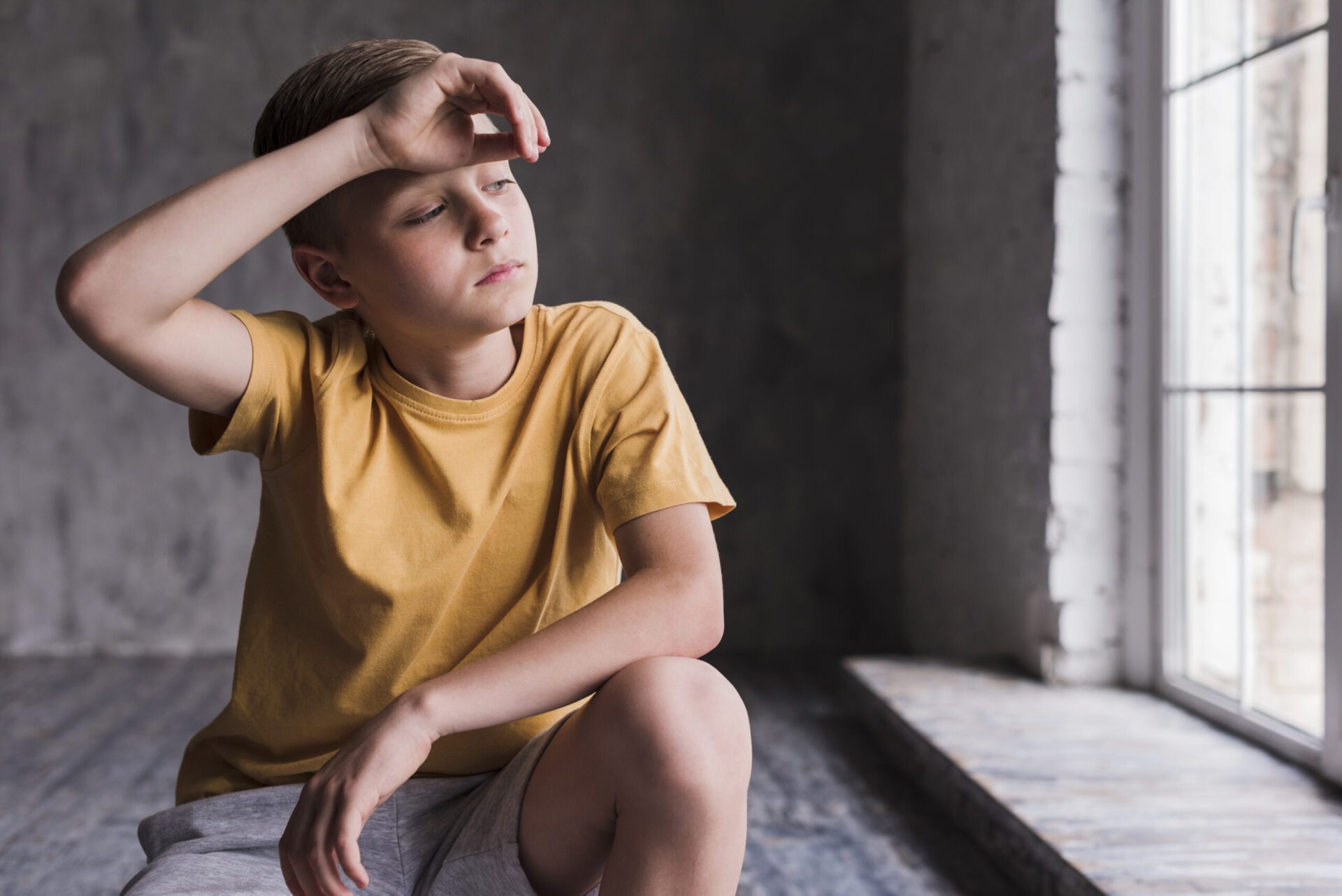 exhausted-boy-with-his-hand-forehead