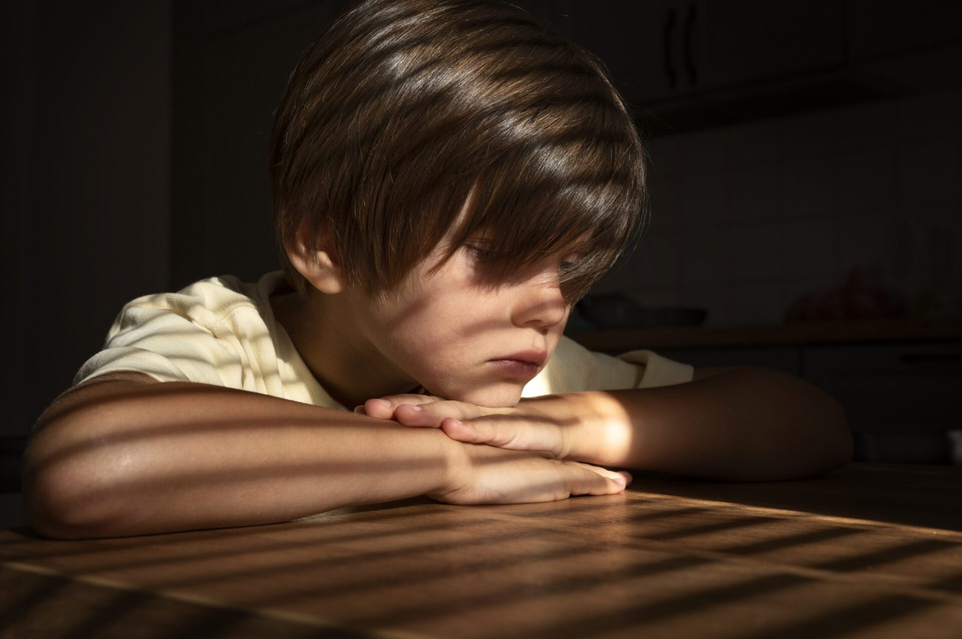 side-view-sad-boy-sitting-indoors-scaled