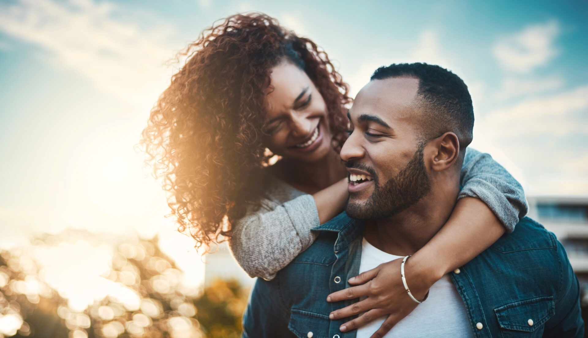 nature-happy-couple-with-piggyback-love-care-bonding-together-outdoor-park-smile-marriage-young-man-woman-embracing-having-fun-date-field-garden-mexico