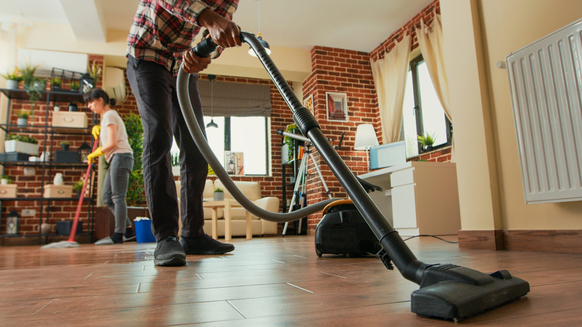 African american man vacuuming floors in living room