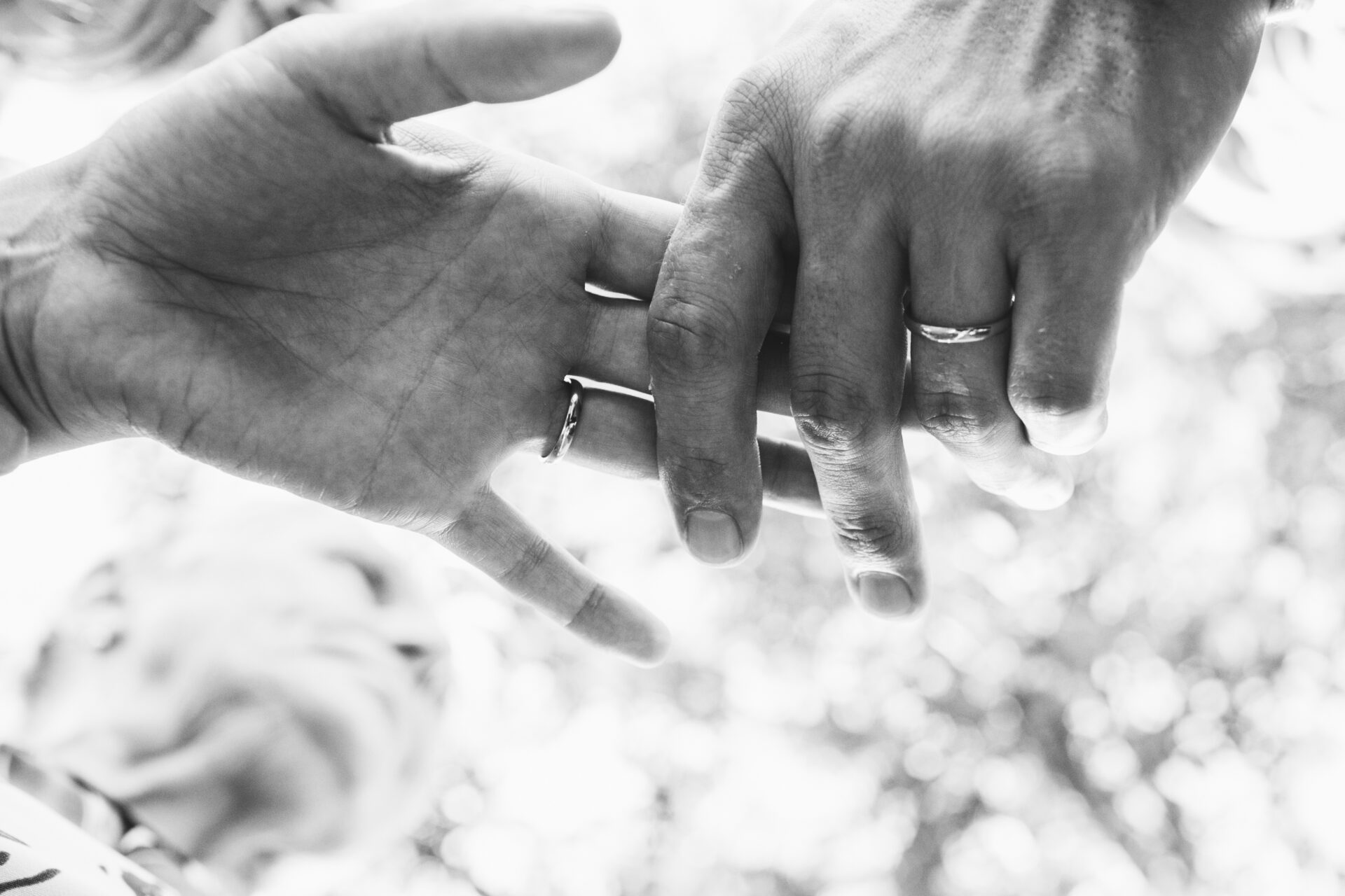 Black and white picture of newlyweds' hands holding each other t